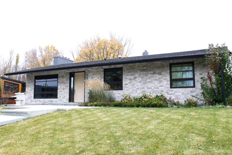 Exterior stone on a modern bungalow by Brandt Plastering