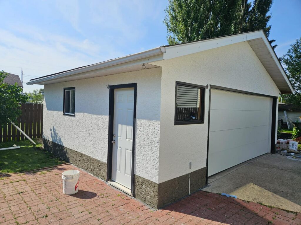 Stucco repair project on detached garage - side view